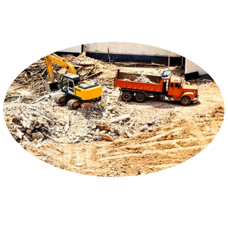 Excavator loading debris into a dump truck for affordable demolition in Port Stephens, NSW.