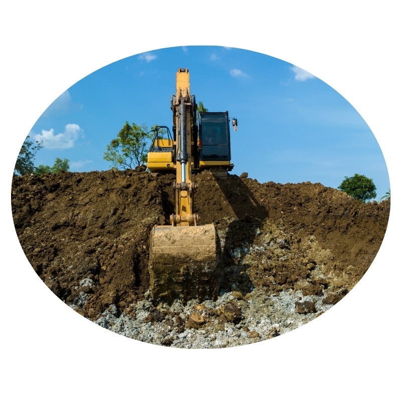 Yellow excavator digging into a dirt mound on a sunny day, with a blue sky in the background. Excavation Central Coast