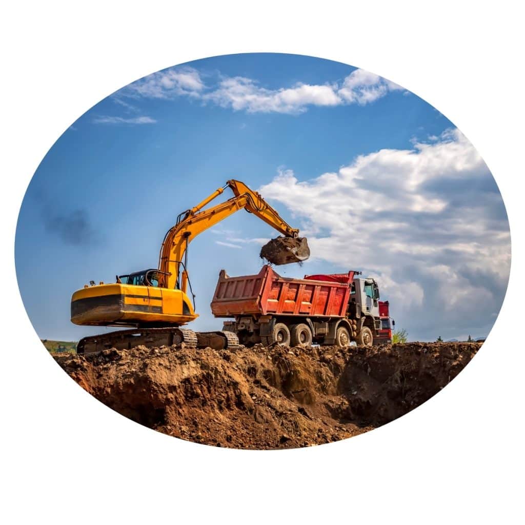 Yellow excavator loading dirt into a dump truck on a construction site. Excavation Contractors Central Coast