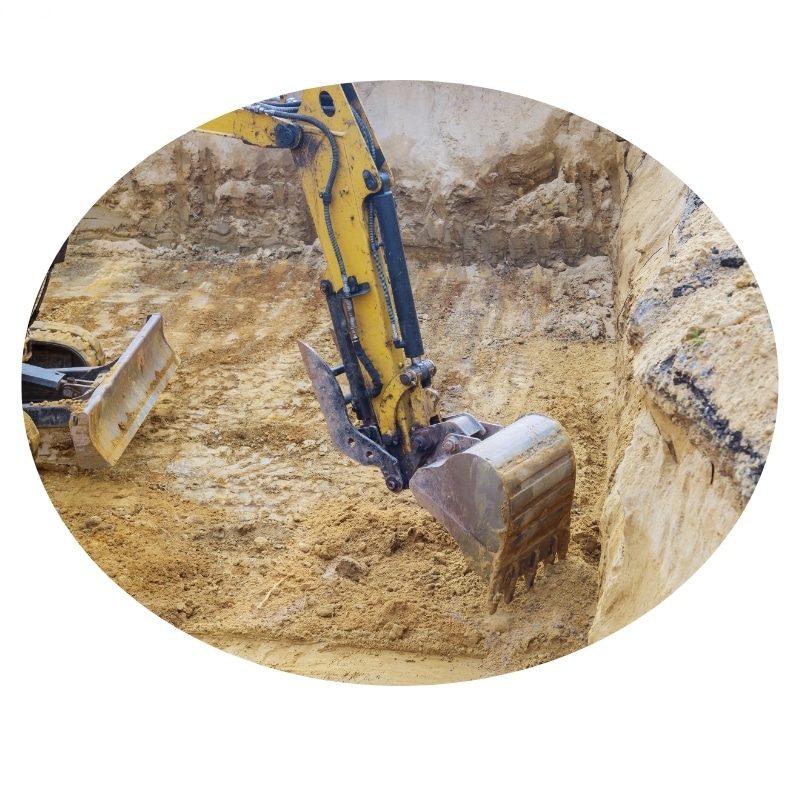 Excavation Hunter Valley: Yellow excavator digging a deep trench in the ground.