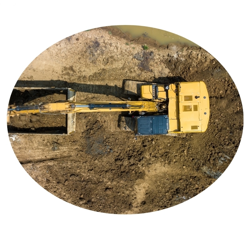 Aerial view of an excavation project in progress near Port Stephens, featuring an excavator digging on a construction site.