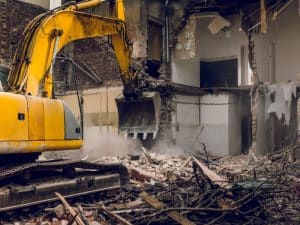 a bulldozer demolishing a building in guidance of structural assessment