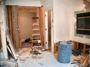 a room with a ladder full of rubbles and demolition equipment indicating demolising a house