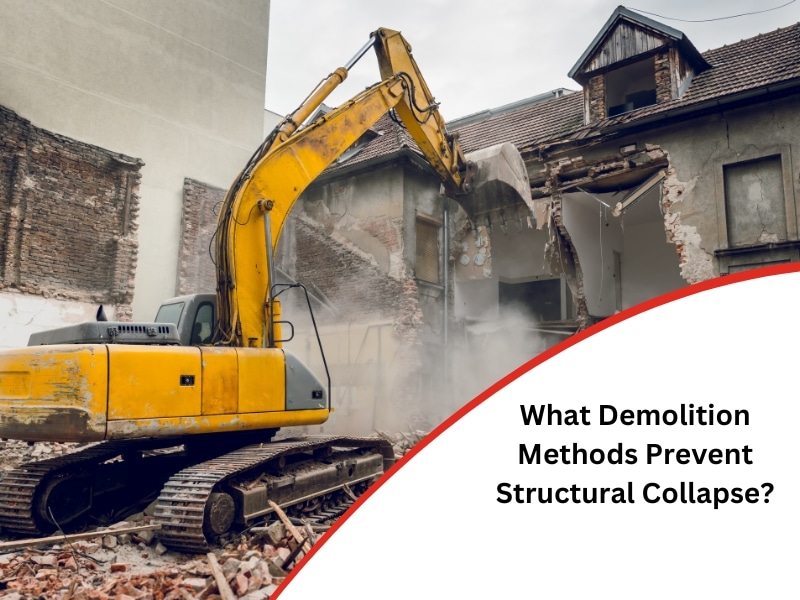 Excavator demolishing a building using a controlled demolition method.