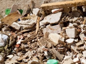 A messy pile of rubble and building waste from a DIY demolition site.