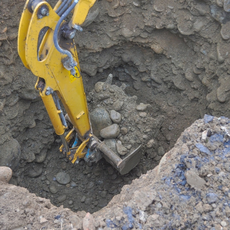 Excavator digging deep rocky soil during detailed excavation Newcastle project.